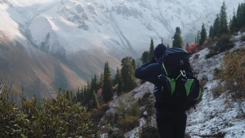 Two people amidst cliffs in the snowy mountains
