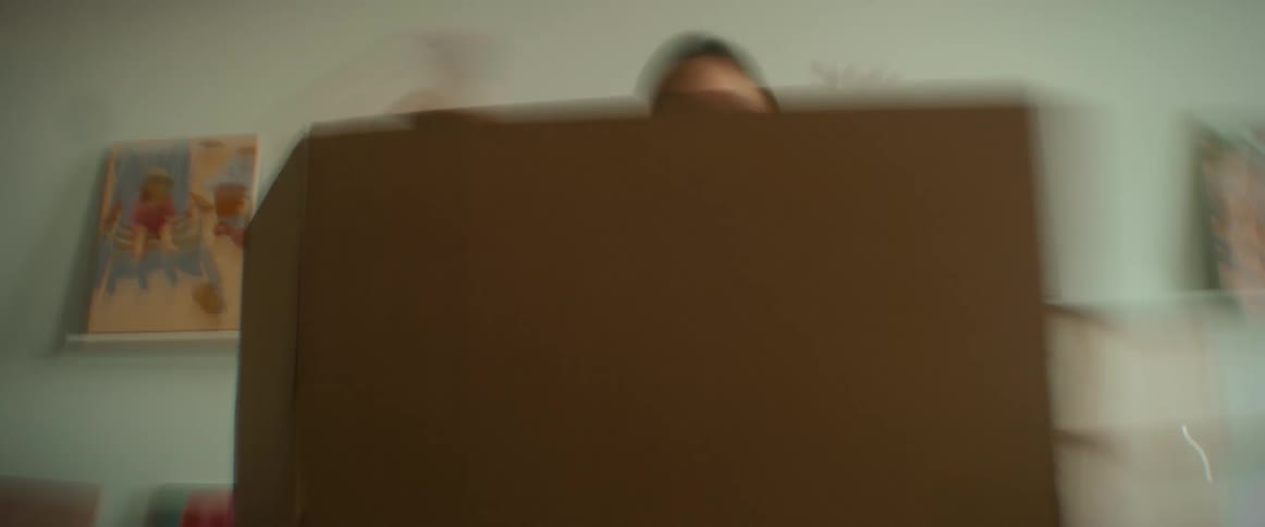 A woman assembling a cardboard box on a table
