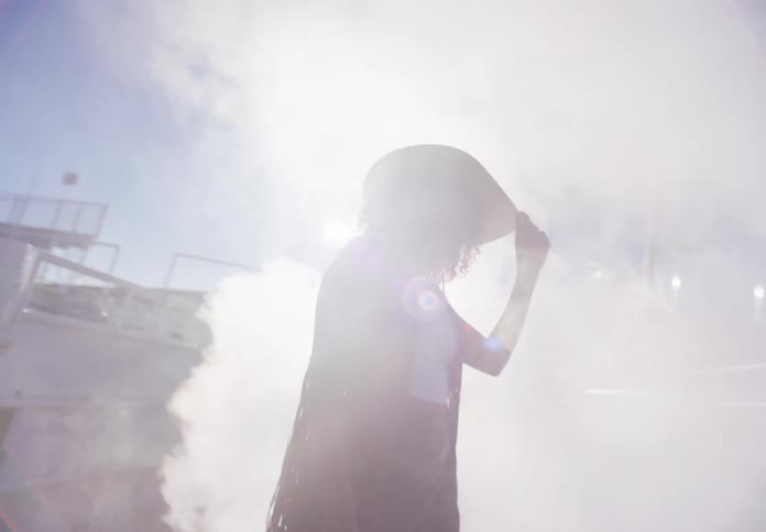 A woman entering a smokecovered rodeo arena