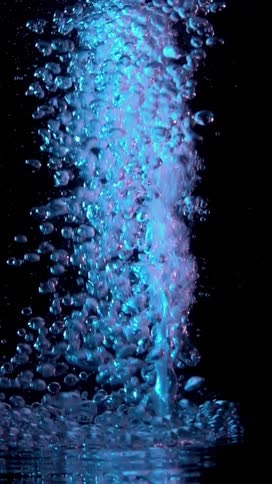 The neon bubbles shoot up and slowly fall