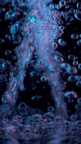 Closeup of water jets forming liquid bubbles