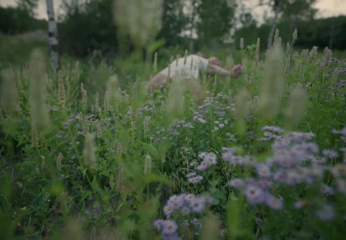 Woman dancing among the flowers in a natural setting in the morning