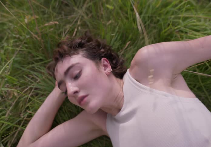 A woman dancing hile lying on the floor