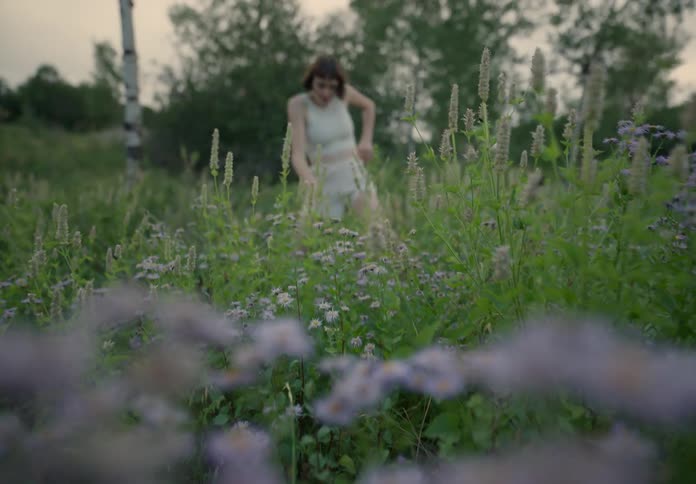 Woman dancing in the midst of nature in a scenic performance
