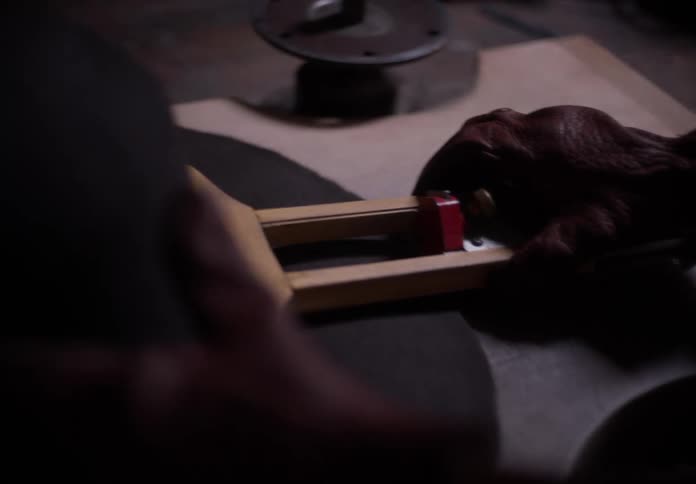 Closeup of hands in gloves adjusting a tool