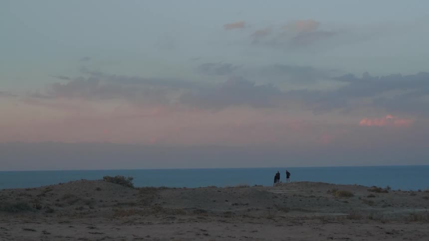 Panorama of a beach facing the sea with people in the morning