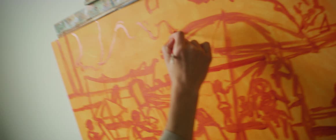 Hand of a woman painting a canvas