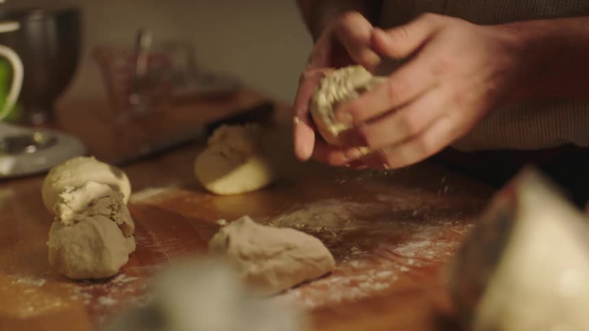 Closeup of a mans hands kneading dough