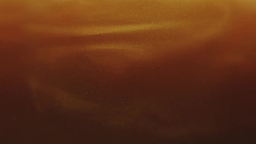 Thick layers of orange tinted clouds flow across the sky