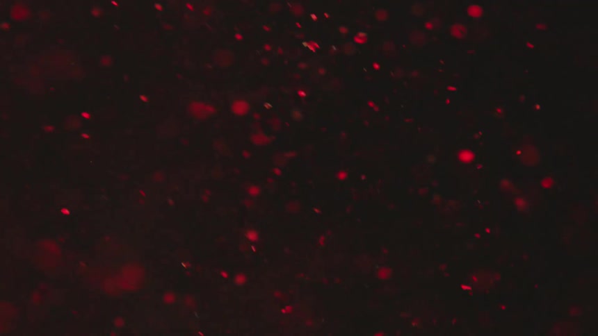 Particles floating in liquid under red lights
