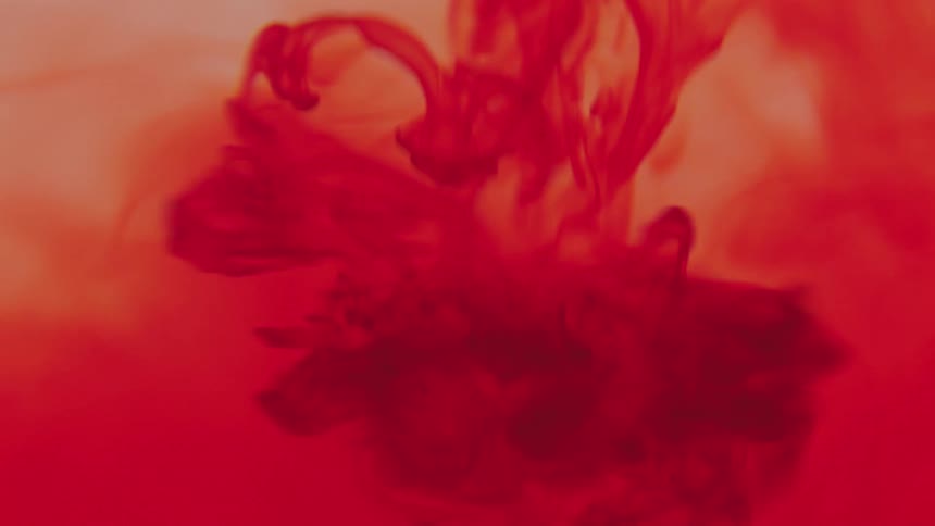 Ink fluid falling into liquid in slow motion