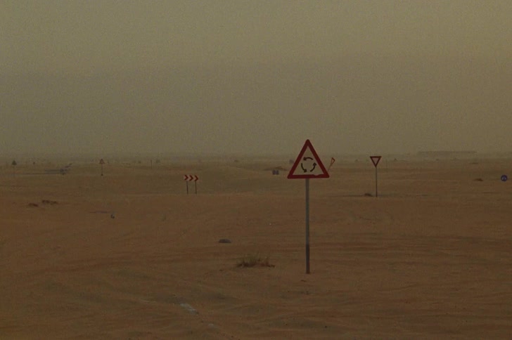 Triangular signs in hazy desert scene