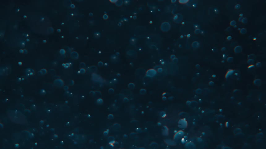 Dense liquid with blue glow in slow motion