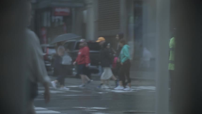 Pedestrians crossing the street on a rainy day