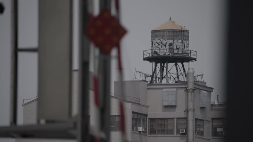 Building with a water tank on its rooftop on a cloudy day