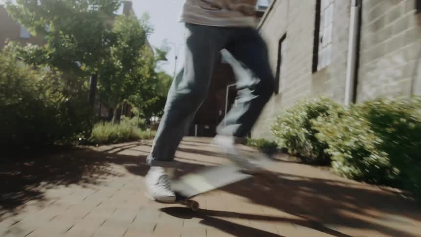 Man spins in his skateboard in the city sidewalk
