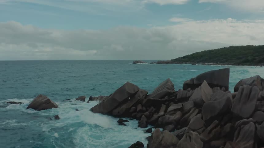 Aerial view of sea waves hitting coastal rock formations