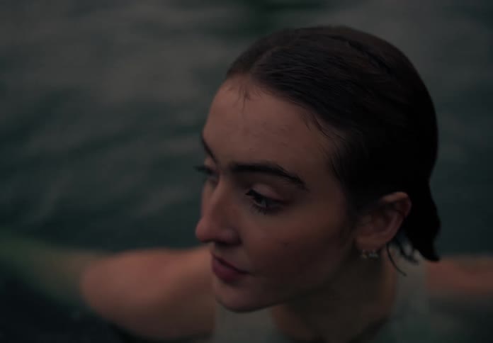 Close up of the face of a woman floating in water
