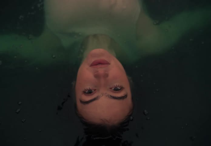 Portrait of a young woman floating in the water