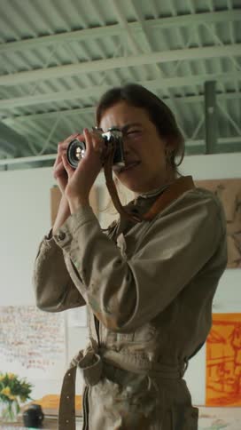 Photographer taking photos while on top of a chair in an indoor space