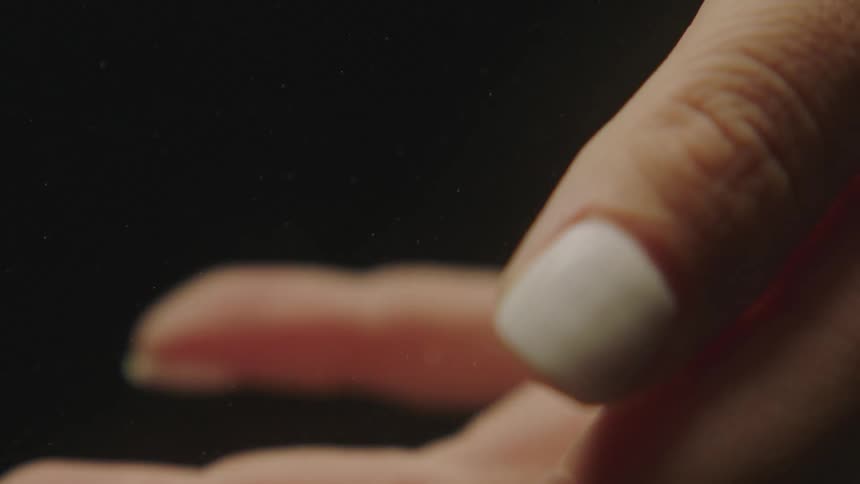 A womans hand slowly moving its fingers