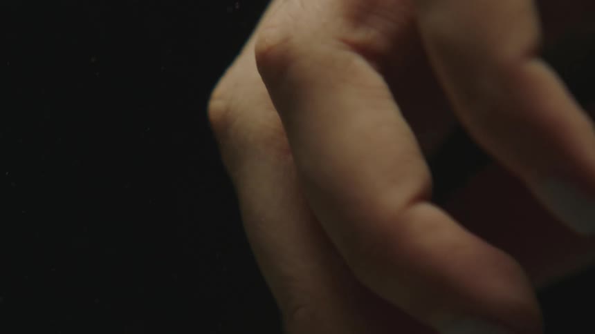 A womans hand slowly opening and closing its fingers