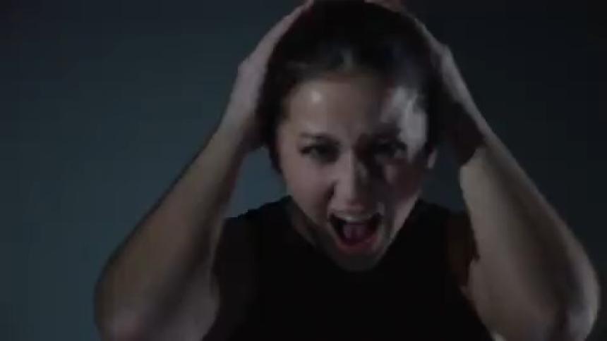 Woman in distress screams under flashing lights