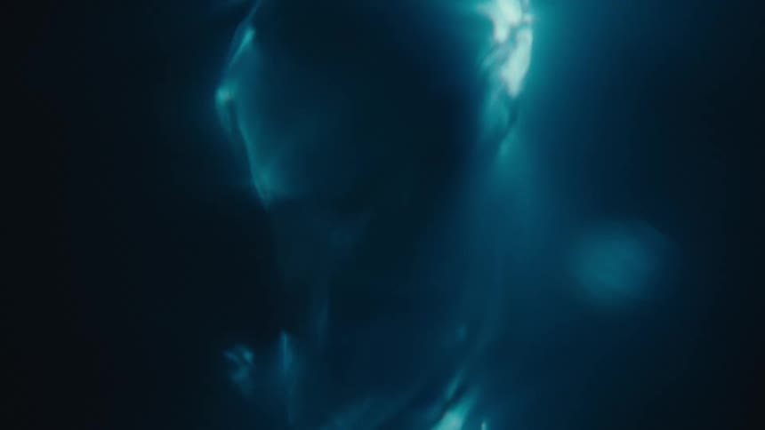 Extreme closeup of a rapidly moving and abstract spiral underwater