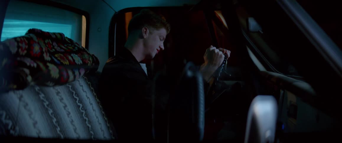 A sad man sitting in the car hitting the steering wheel