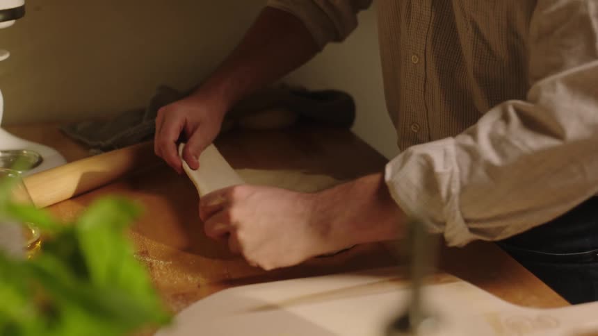 Man cooking pasta with his hands under a countertop