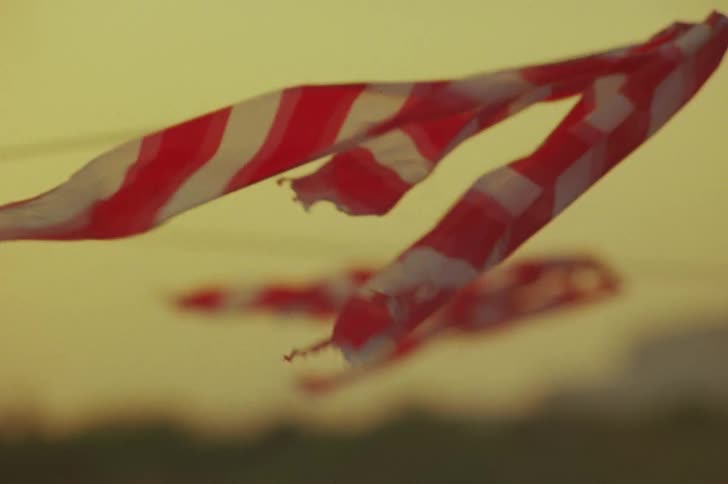 Wind blowing a red cloth on a thin line rope