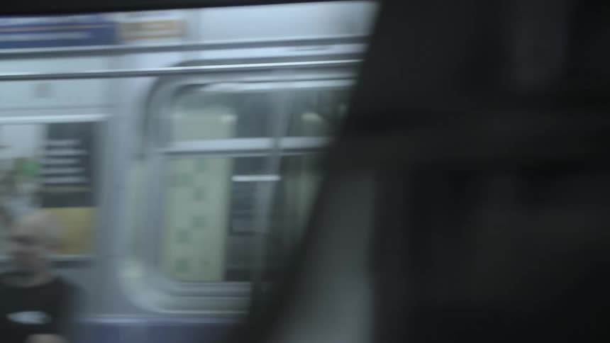 A subway with many windows passing through a terminal