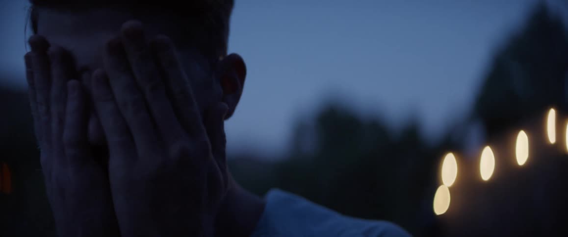 Closeup of a mans face feeling sad placing his hands on his face