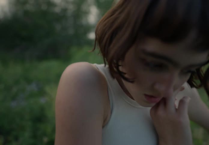 Portrait of a woman dancing in a field amidst nature