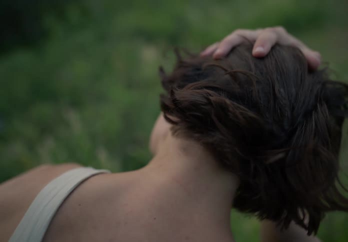 A person is facing away from you and runs his hand over your neck and hair