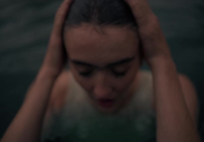 Head of a lady pops out of the water during the day
