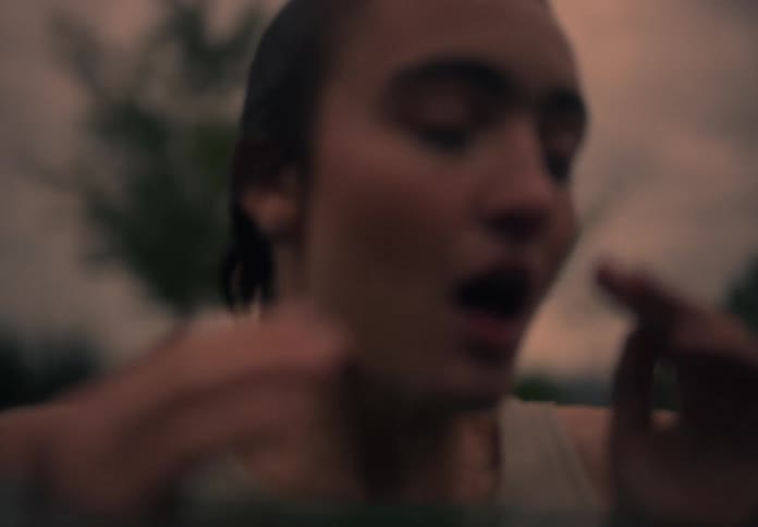 Head of a lady pops out of the water at sunset