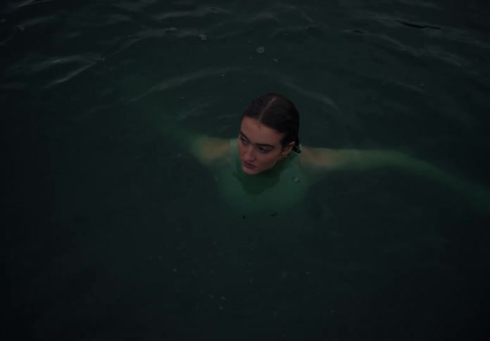 Woman swimming on a lake