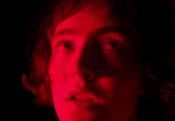 Portrait of a woman at night with red light under her face