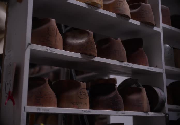 The shelves are full of different hats