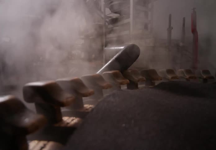 Machine inside a factory releasing smoke