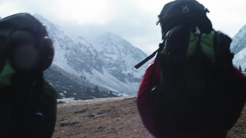 Group of people hiking next to the mountains