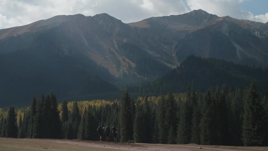 Group of hikers contemplate a large mountain range