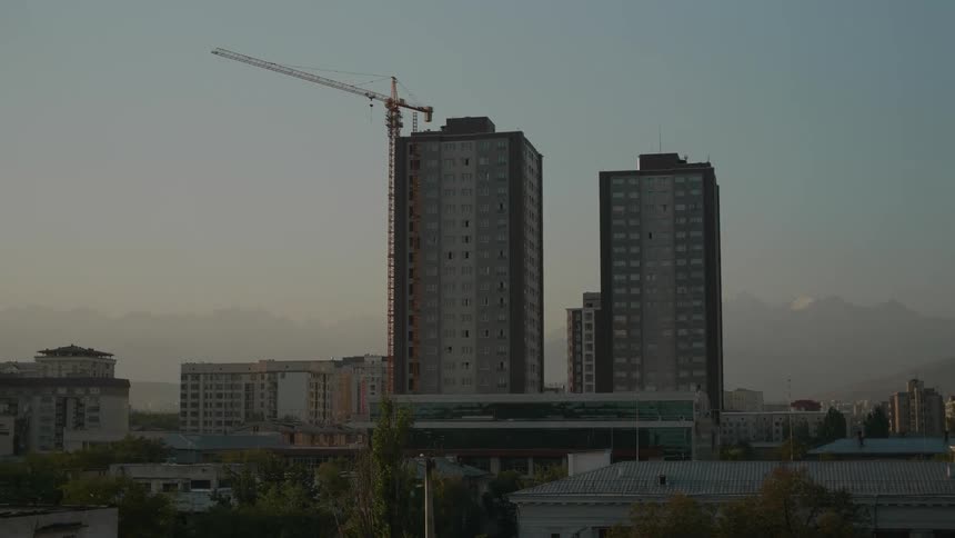 Construction crane next to residential buildings in the city
