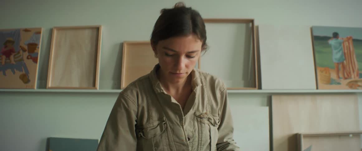 Female painter painting a canvas on the table