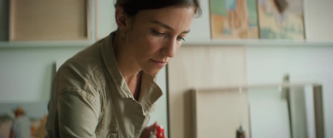 A woman concentrated on looking at a painting