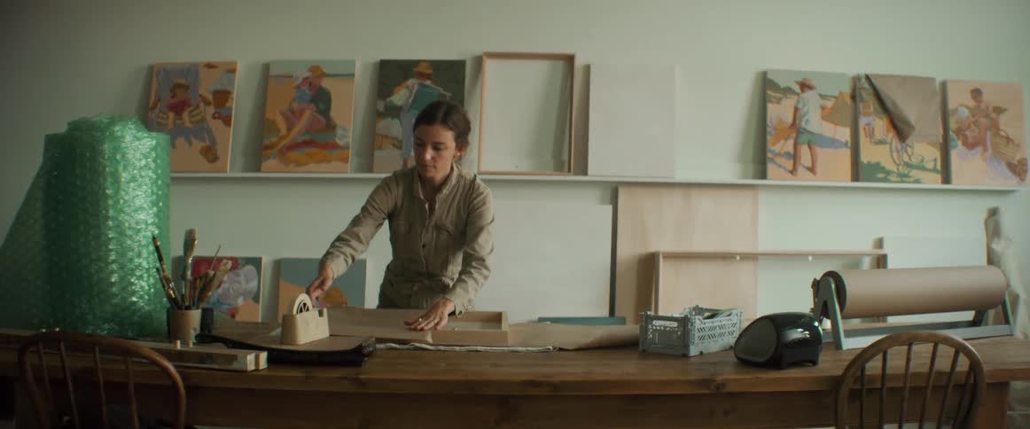 Artist wrapping a painting for shipping