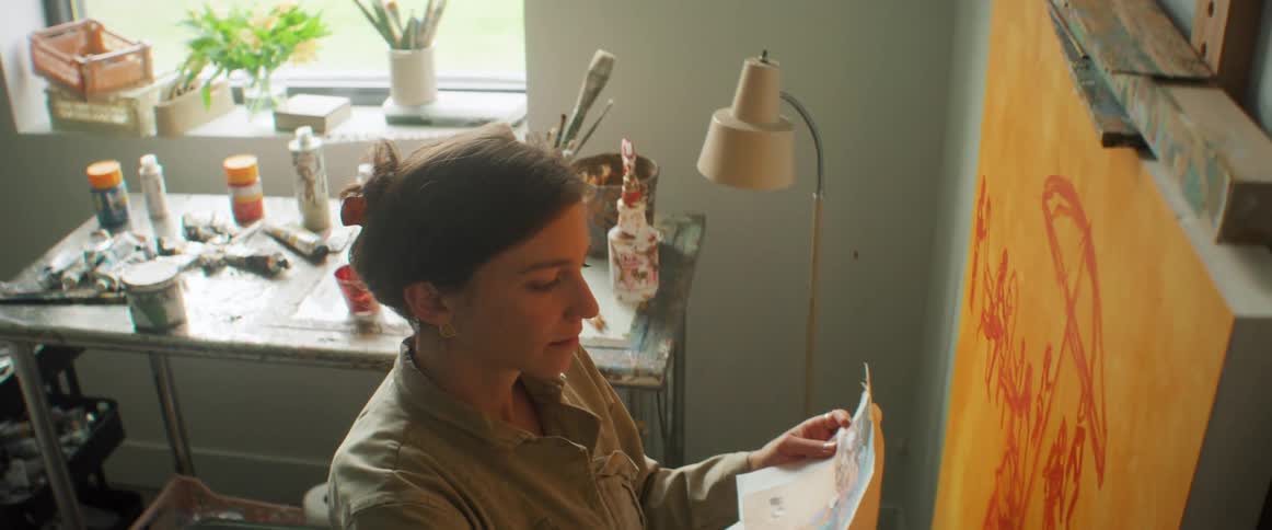 Painter with a brush painting a canvas