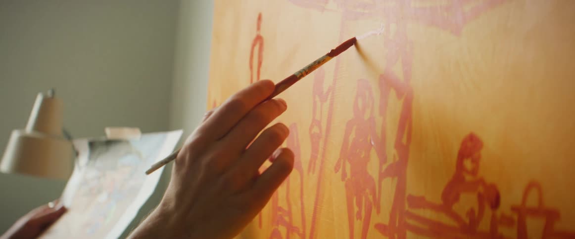Closeup of a womans hands painting a canvas