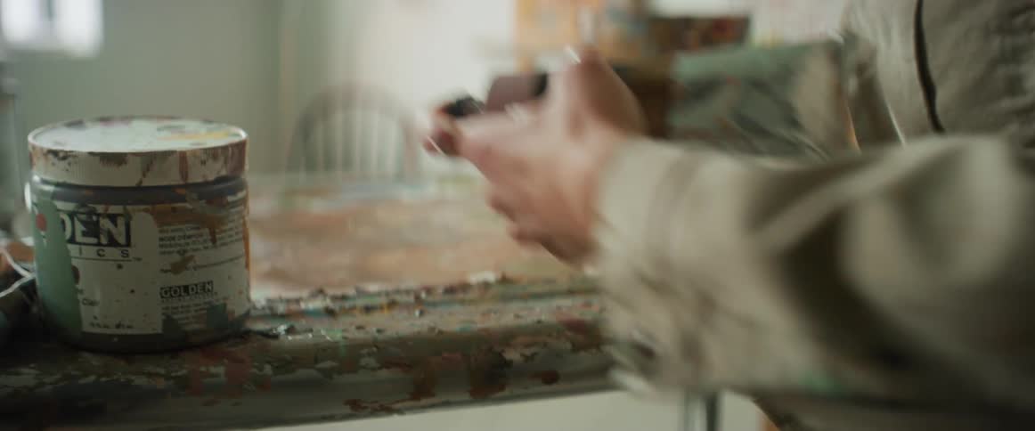 Artist handling paint tubes in the studio